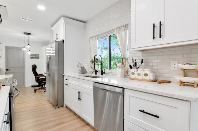 125 Siobhan Ave, Tampa, FL 33613 - kitchen featuring backsplash, a sink, appliances with stainless steel finishes, and visible vents