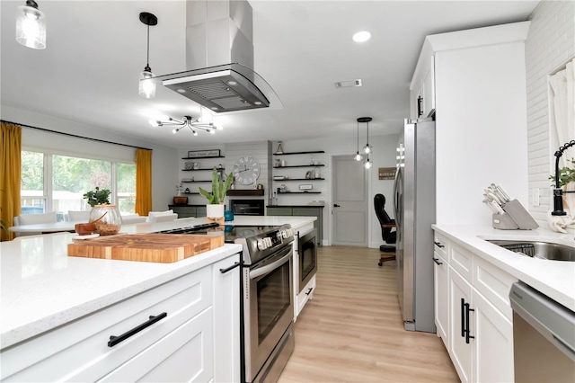 125 Siobhan Ave, Tampa, FL 33613 - kitchen with island exhaust hood, a sink, decorative light fixtures, and appliances with stainless steel finishes