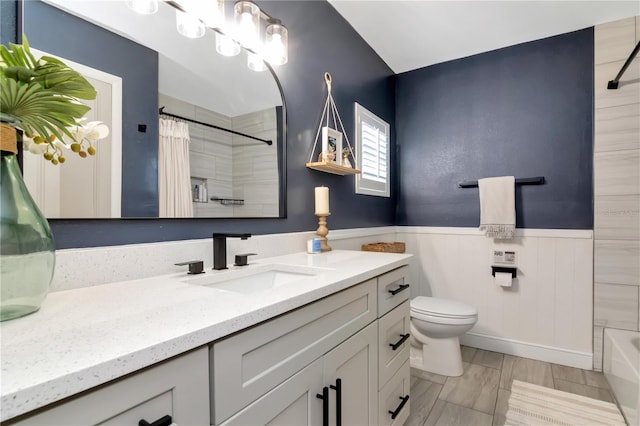 125 Siobhan Ave, Tampa, FL 33613 - bathroom featuring vanity, toilet, and wainscoting