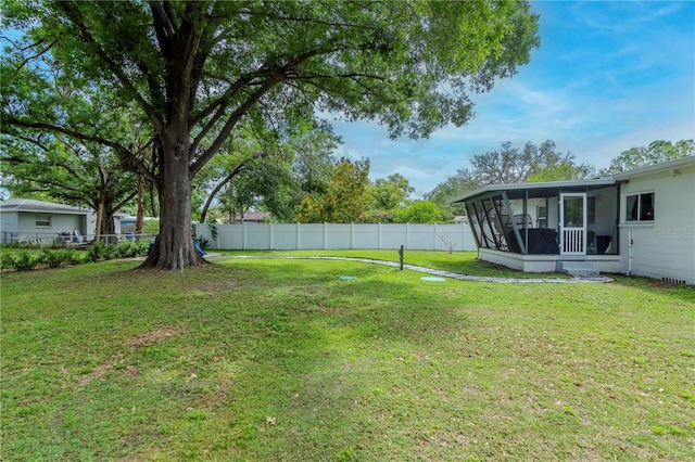 125 Siobhan Ave, Tampa, FL 33613 - view of yard featuring a sunroom and a fenced backyard