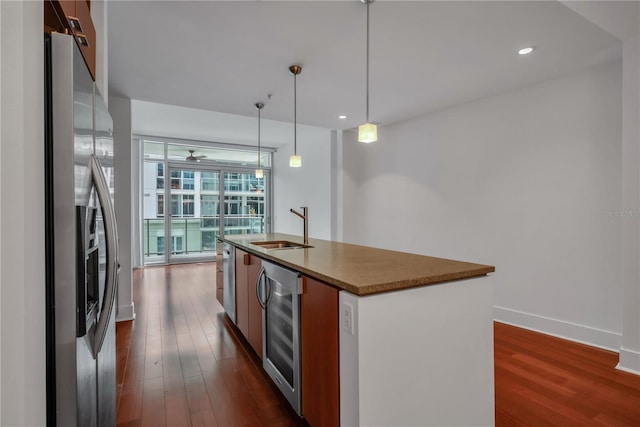 kitchen featuring a sink, dark wood finished floors, a center island with sink, beverage cooler, and stainless steel refrigerator with ice dispenser