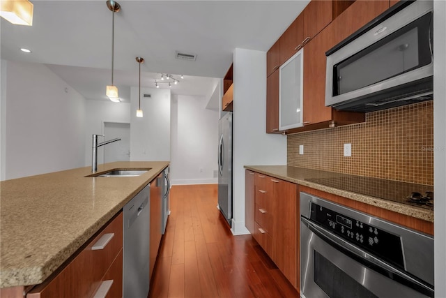 kitchen featuring modern cabinets, tasteful backsplash, and appliances with stainless steel finishes