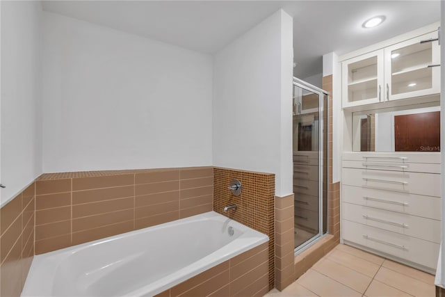 full bathroom with a garden tub, tile patterned floors, and a stall shower
