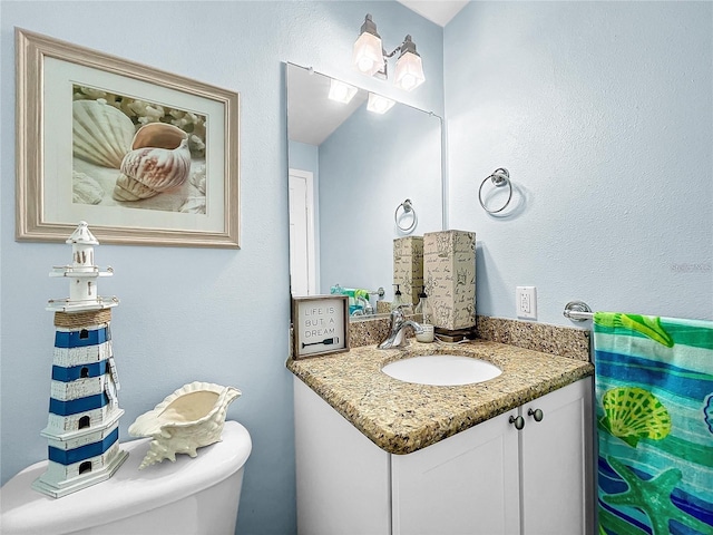 bathroom featuring vanity and toilet