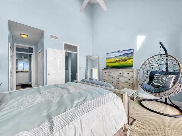 bedroom featuring a high ceiling, baseboards, and carpet floors