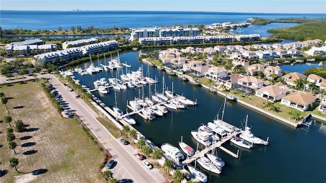 aerial view of property's location featuring a nearby body of water and numerous boat docks