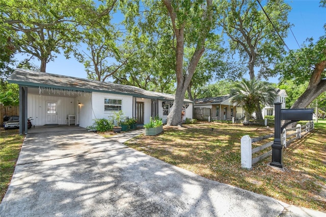 3202 W Coachman Ave, Tampa, FL 33611 - ranch-style house featuring driveway, a carport, and board and batten siding