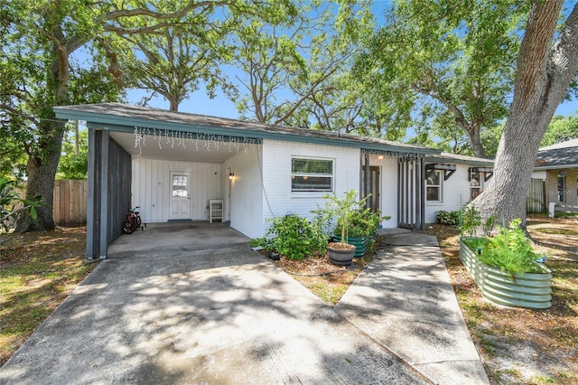 3202 W Coachman Ave, Tampa, FL 33611 - view of front of property featuring a carport, driveway, and brick siding