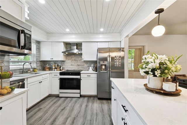 3202 W Coachman Ave, Tampa, FL 33611 - kitchen with appliances with stainless steel finishes, wall chimney exhaust hood, decorative backsplash, white cabinets, and wood ceiling