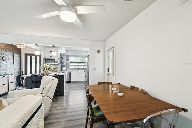 3202 W Coachman Ave, Tampa, FL 33611 - dining area featuring wood finished floors and a ceiling fan