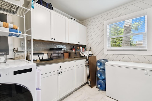 3202 W Coachman Ave, Tampa, FL 33611 - laundry room with washer / dryer, cabinet space, and light marble finish floors