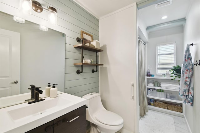 3202 W Coachman Ave, Tampa, FL 33611 - full bath with vanity, toilet, wooden walls, and baseboards