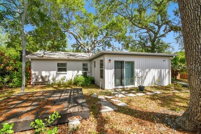 3202 W Coachman Ave, Tampa, FL 33611 - rear view of property with board and batten siding