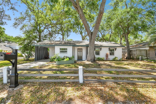3202 W Coachman Ave, Tampa, FL 33611 - view of front of house with a fenced front yard, driveway, and an attached carport
