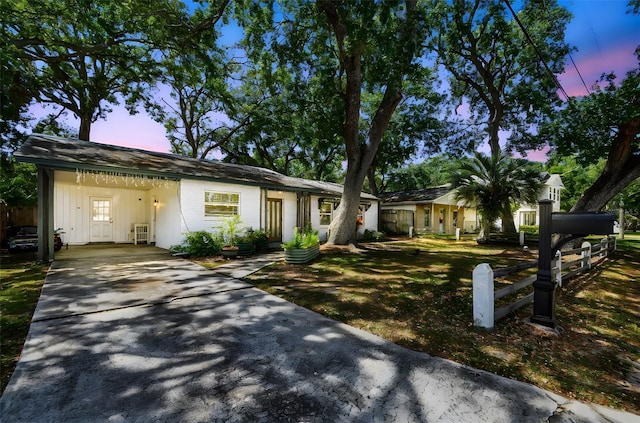 3202 W Coachman Ave, Tampa, FL 33611 - ranch-style house featuring concrete driveway and a carport
