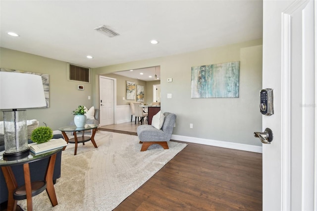 sitting room with baseboards, visible vents, recessed lighting, and wood finished floors