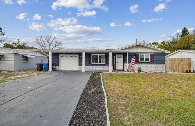 ranch-style house featuring fence, an attached garage, brick siding, a front lawn, and driveway