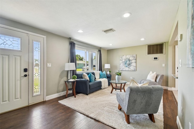 living room with dark wood finished floors, recessed lighting, baseboards, and visible vents