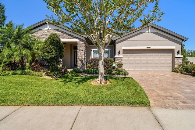 21627 Pearl Crescent Ct, Land O Lakes, FL 34637 - view of front of house featuring an attached garage, driveway, stucco siding, and stone siding