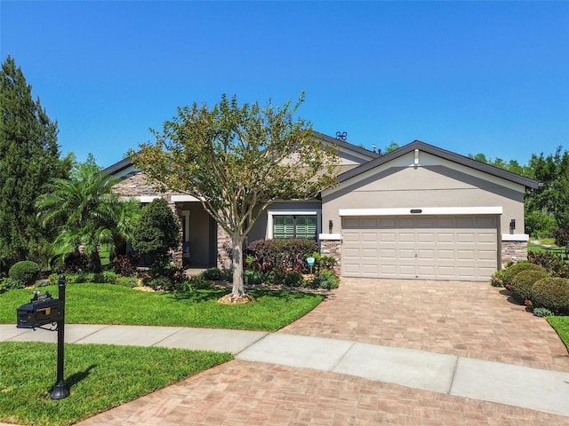 21627 Pearl Crescent Ct, Land O Lakes, FL 34637 - view of front of property featuring a front yard, stone siding, decorative driveway, and an attached garage