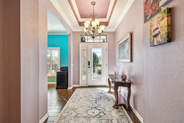 21627 Pearl Crescent Ct, Land O Lakes, FL 34637 - foyer entrance with a textured wall, arched walkways, a notable chandelier, and ornamental molding