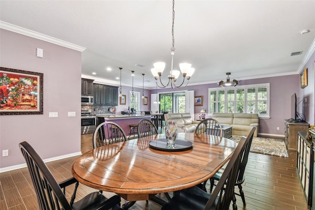 21627 Pearl Crescent Ct, Land O Lakes, FL 34637 - dining room featuring visible vents, baseboards, an inviting chandelier, and wood tiled floor