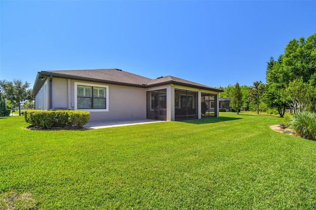 21627 Pearl Crescent Ct, Land O Lakes, FL 34637 - rear view of house with a sunroom, a patio, a yard, and stucco siding