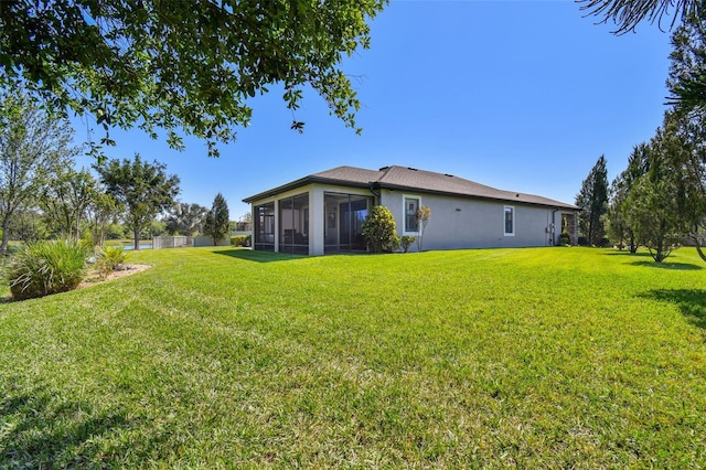 21627 Pearl Crescent Ct, Land O Lakes, FL 34637 - rear view of property with a yard, a sunroom, and stucco siding