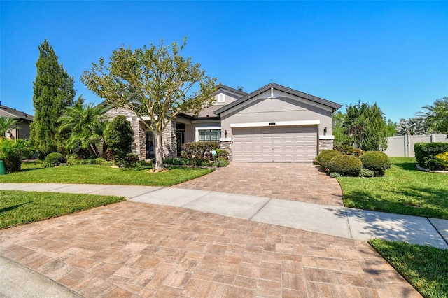 21627 Pearl Crescent Ct, Land O Lakes, FL 34637 - view of front of property featuring a front yard, stone siding, a garage, fence, and decorative driveway