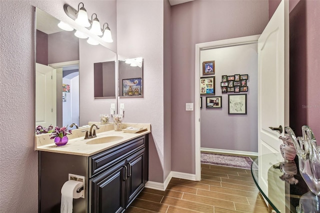 21627 Pearl Crescent Ct, Land O Lakes, FL 34637 - bathroom featuring vanity, baseboards, and wood tiled floor