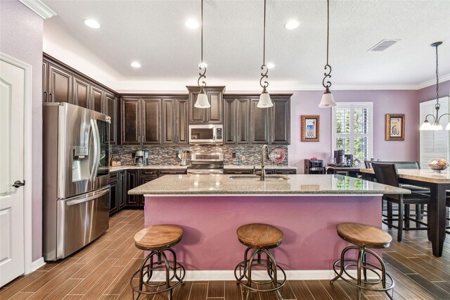 21627 Pearl Crescent Ct, Land O Lakes, FL 34637 - kitchen with visible vents, wood finished floors, and stainless steel appliances