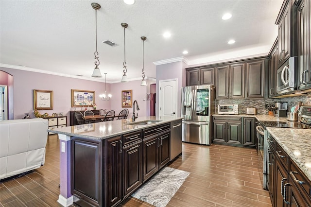 21627 Pearl Crescent Ct, Land O Lakes, FL 34637 - kitchen featuring visible vents, a sink, ornamental molding, and appliances with stainless steel finishes