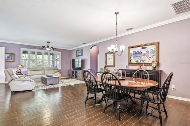 21627 Pearl Crescent Ct, Land O Lakes, FL 34637 - dining area featuring visible vents, arched walkways, a notable chandelier, and dark wood finished floors