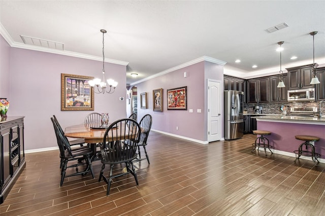 21627 Pearl Crescent Ct, Land O Lakes, FL 34637 - dining space featuring dark wood-style flooring, visible vents, baseboards, and an inviting chandelier