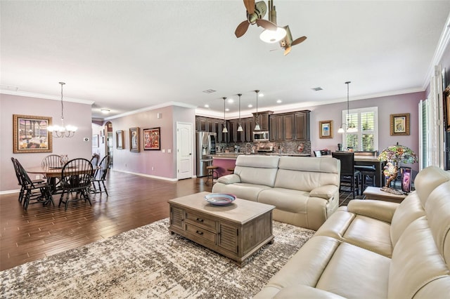 21627 Pearl Crescent Ct, Land O Lakes, FL 34637 - living room featuring dark wood-style flooring, baseboards, ornamental molding, and ceiling fan with notable chandelier