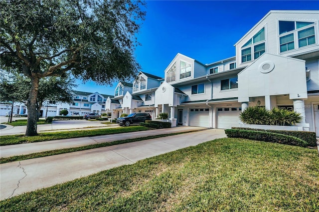 14723 Seminole Trl, Seminole, FL 33776 - multi unit property with concrete driveway, a residential view, a front lawn, and a garage