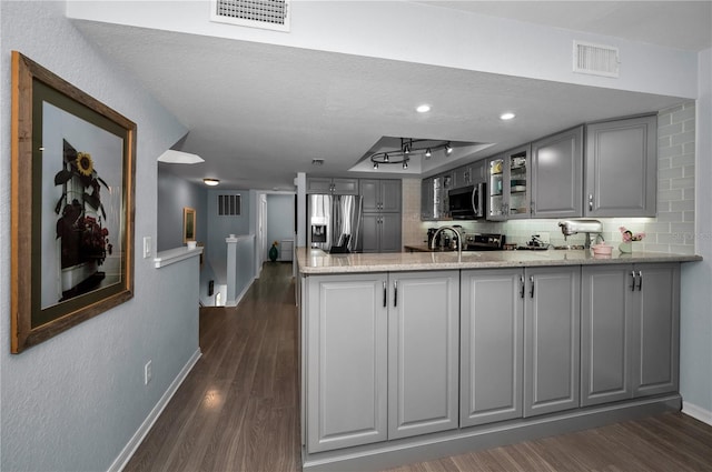 14723 Seminole Trl, Seminole, FL 33776 - kitchen with visible vents, a peninsula, gray cabinets, and appliances with stainless steel finishes