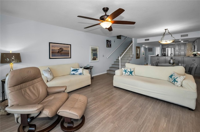 14723 Seminole Trl, Seminole, FL 33776 - living area featuring visible vents, a ceiling fan, wood finished floors, and stairway