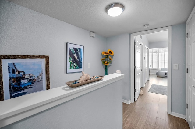14723 Seminole Trl, Seminole, FL 33776 - hallway with a textured ceiling, baseboards, and wood finished floors