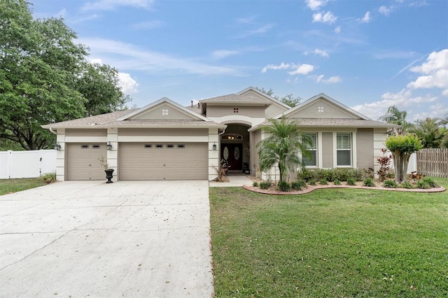 12304 Freesia Ct, Riverview, FL 33569 - view of front of house featuring stucco siding, a front yard, fence, an attached garage, and concrete driveway