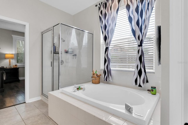 12304 Freesia Ct, Riverview, FL 33569 - full bath featuring tile patterned flooring, a garden tub, a stall shower, and a healthy amount of sunlight
