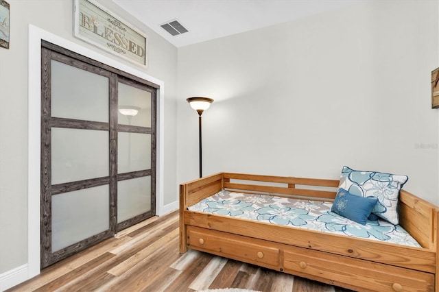 12304 Freesia Ct, Riverview, FL 33569 - bedroom featuring wood finished floors, baseboards, and visible vents