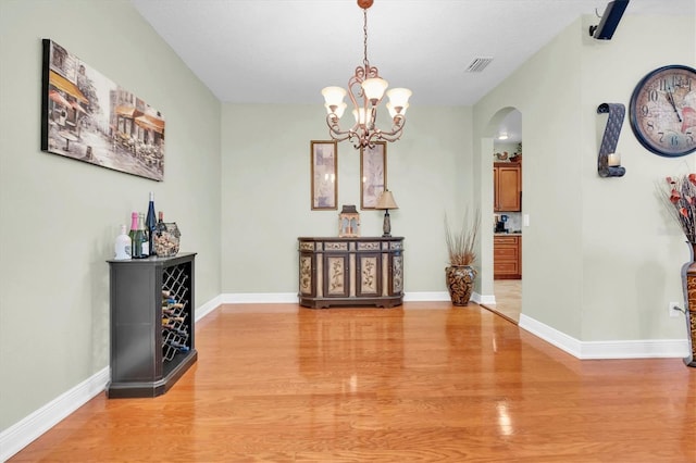 12304 Freesia Ct, Riverview, FL 33569 - dining room with light wood-style floors, arched walkways, visible vents, and baseboards