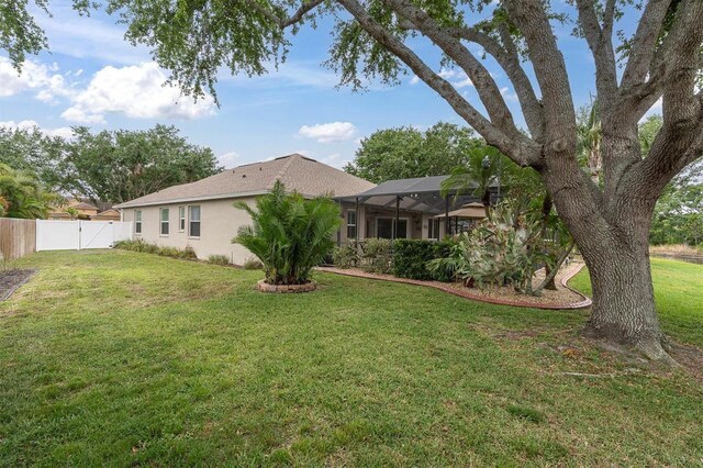 12304 Freesia Ct, Riverview, FL 33569 - view of yard featuring a fenced backyard and a lanai