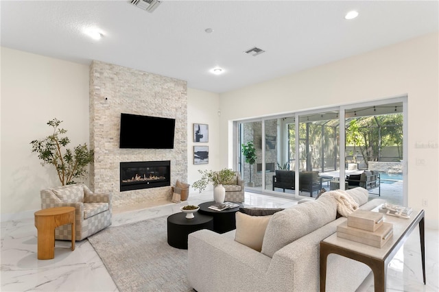 living area featuring marble finish floor, recessed lighting, a stone fireplace, and visible vents