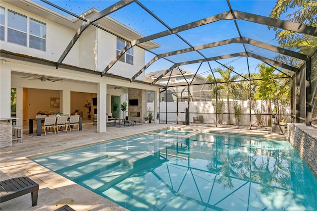 view of pool with ceiling fan, a lanai, fence, and a patio