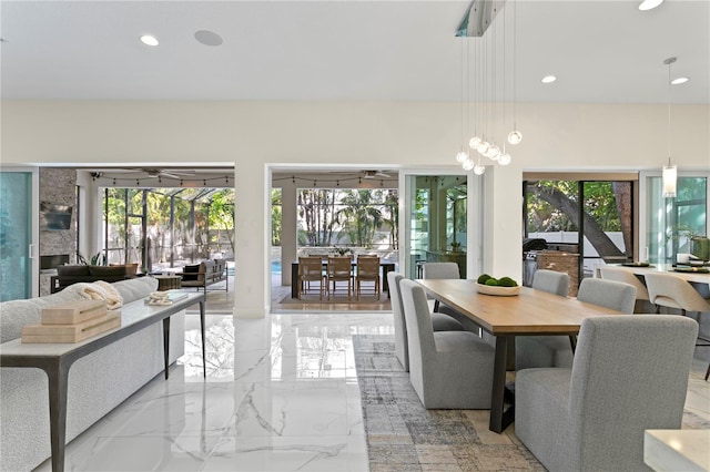 dining area featuring marble finish floor, recessed lighting, and a wealth of natural light