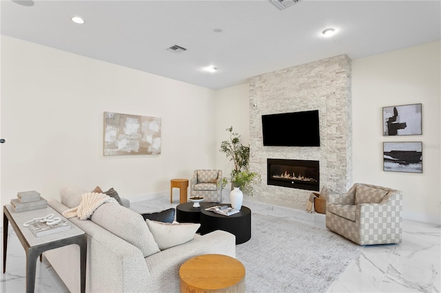 living area featuring visible vents, baseboards, marble finish floor, a fireplace, and recessed lighting