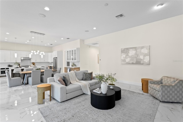 living room featuring marble finish floor, baseboards, visible vents, and recessed lighting