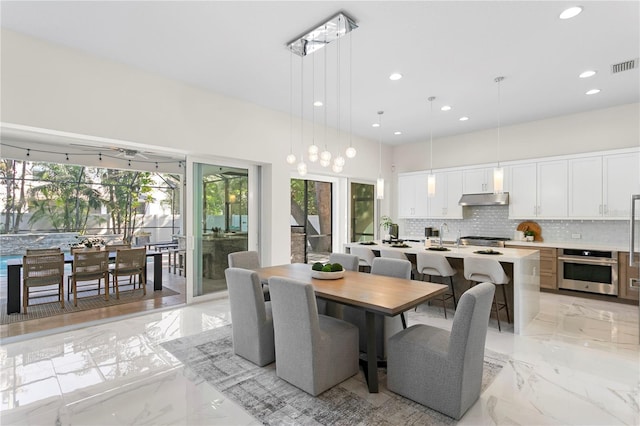 dining area featuring marble finish floor, visible vents, and recessed lighting